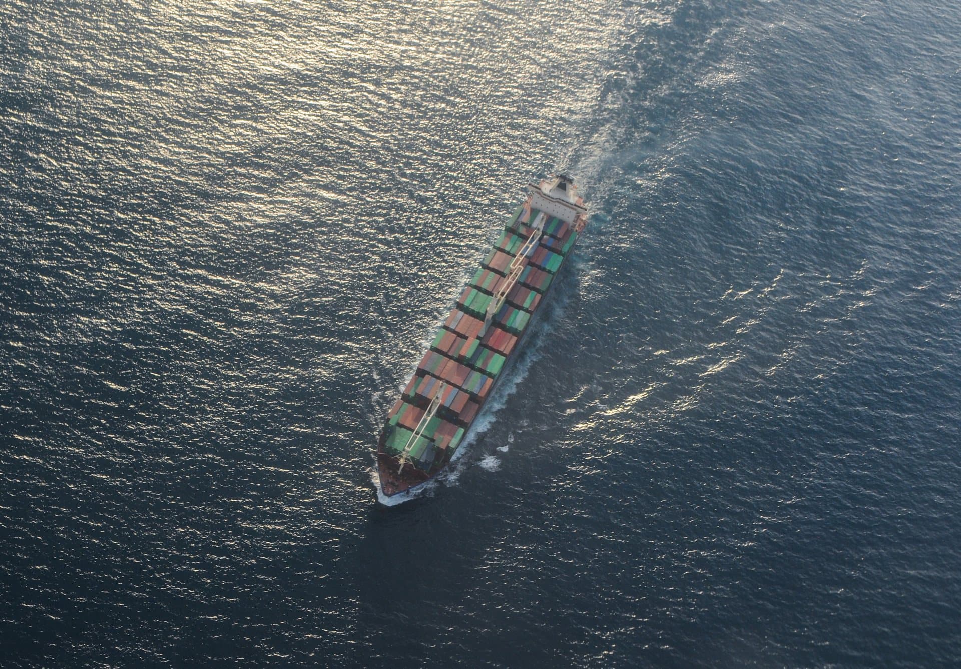 Aerial view of container vessel crossing ocean